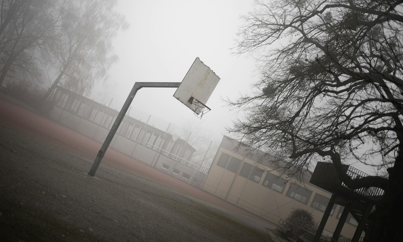 Outdoor basketball hoop in fog